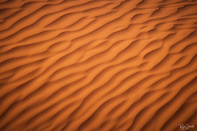 Desert sand up close creates an abstract wave pattern with beautiful shadows and light. Appears as if its the ocean floor without water.