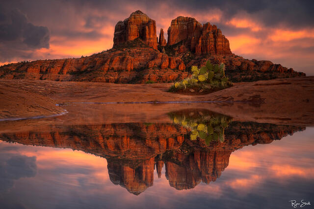 A beautiful sunrise in Sedona Arizona is accentuated by re reflection pond in front of Cathedral Rock