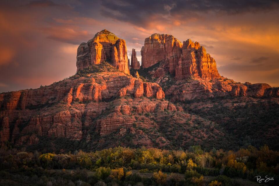 Fine art landscape photograph of Cathedral Rock in Sedona, Arizona glowing in warm sunset light, showcasing red rock formations and dramatic desert scenery.