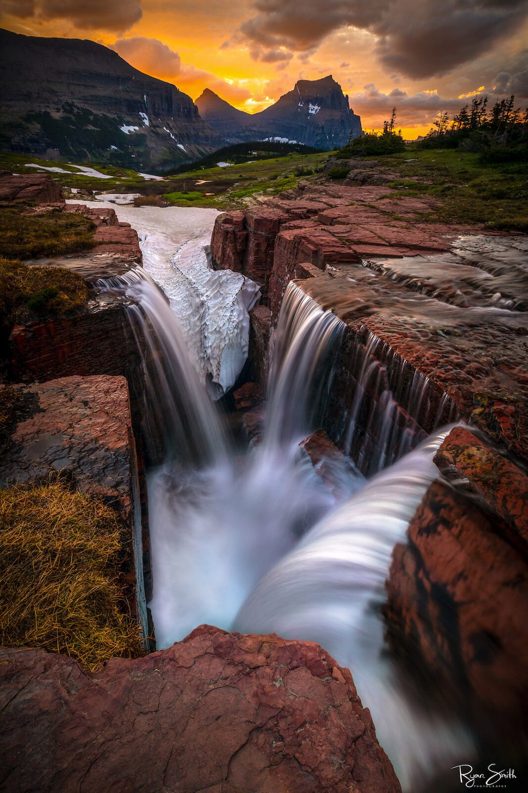 Triple Falls within Glacier National Park offers a serene view of majestic mountain Peaks, Flowers, and Water. Perfect serenity...
